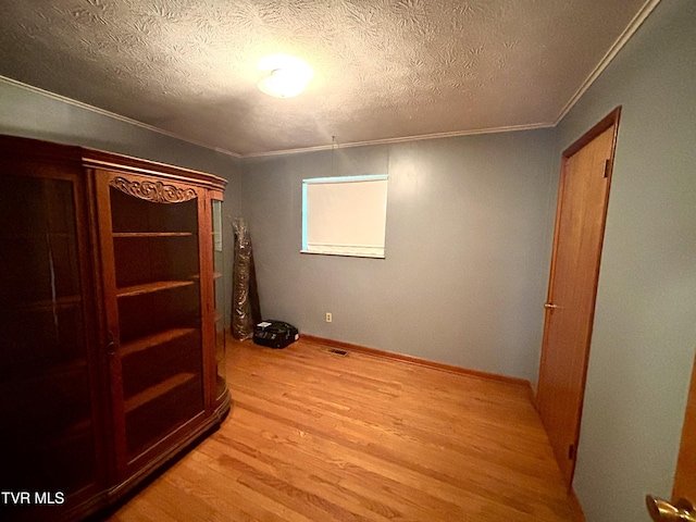 6361 Dr Thomas Walker Rd, Rose Hill, VA 24281 - unfurnished bedroom with light wood finished floors, crown molding, and a textured ceiling