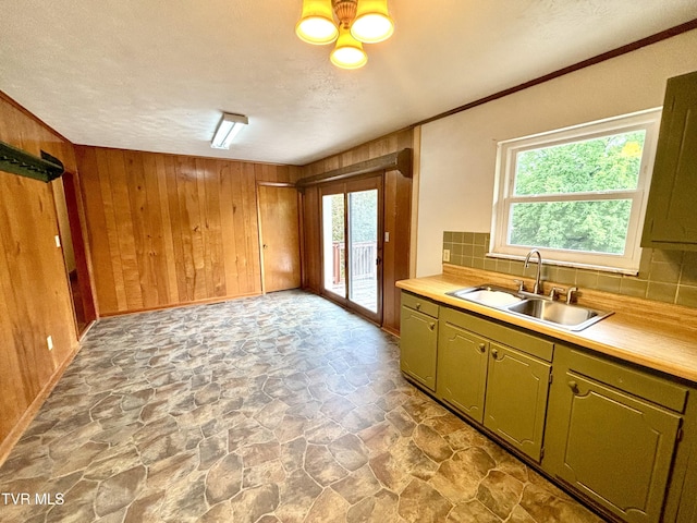 6361 Dr Thomas Walker Rd, Rose Hill, VA 24281 - kitchen with stone finish flooring, decorative backsplash, wooden walls, light countertops, and a textured ceiling