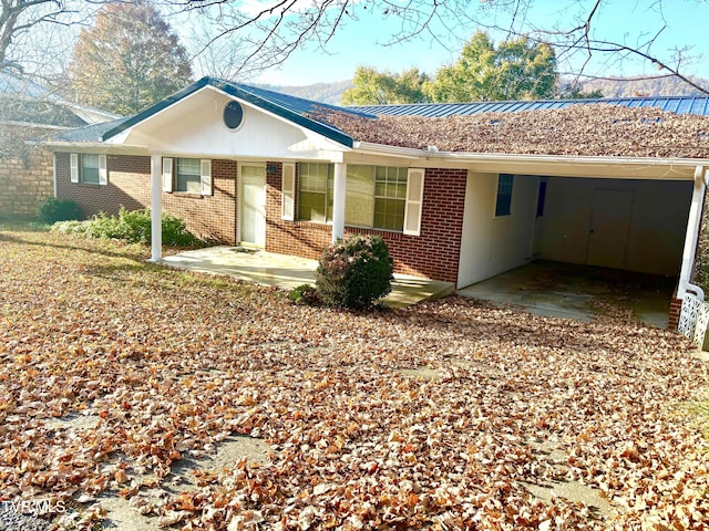 6361 Dr Thomas Walker Rd, Rose Hill, VA 24281 - ranch-style house featuring brick siding, an attached carport, a metal roof, and a standing seam roof