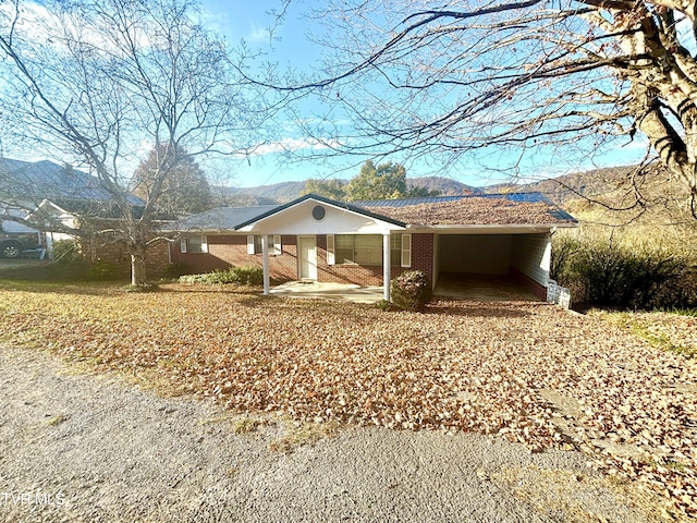 6361 Dr Thomas Walker Rd, Rose Hill, VA 24281 - view of home's exterior featuring brick siding, a carport, a porch, and a mountain view