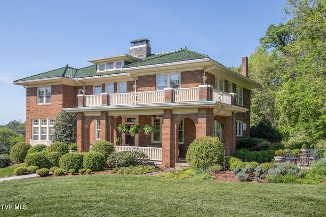 940 Park St, Bristol, VA 24201 - rear view of house featuring a balcony, covered porch, a chimney, a lawn, and brick siding