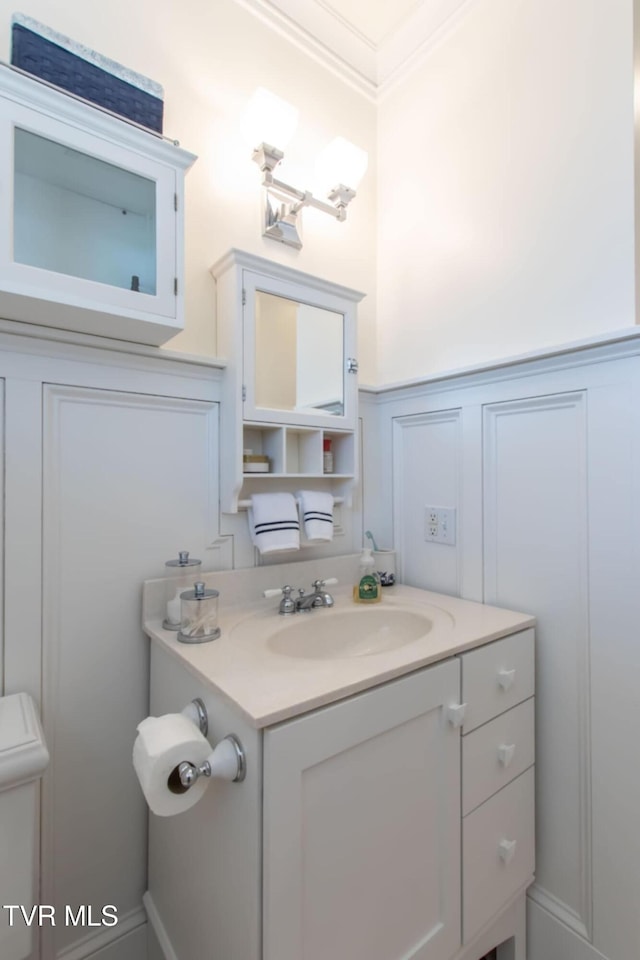 940 Park St, Bristol, VA 24201 - bathroom with vanity, a decorative wall, crown molding, and wainscoting