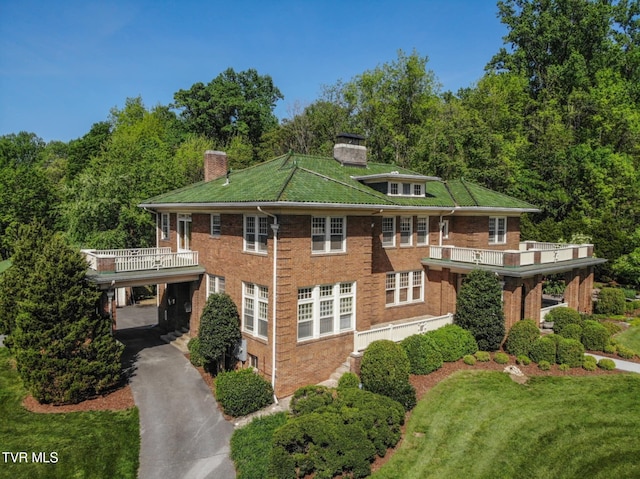 940 Park St, Bristol, VA 24201 - view of front of property with a chimney, driveway, a front yard, brick siding, and a balcony
