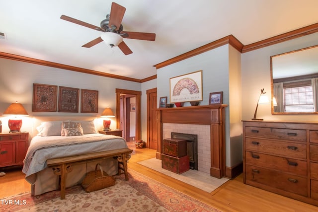 940 Park St, Bristol, VA 24201 - bedroom with crown molding, light wood-type flooring, a wood stove, and a ceiling fan