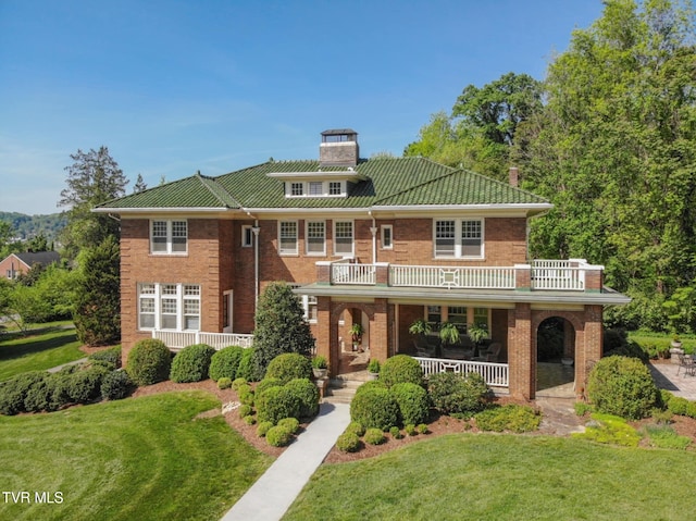 940 Park St, Bristol, VA 24201 - view of front of home with a porch, a chimney, a front yard, brick siding, and a balcony