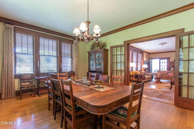 940 Park St, Bristol, VA 24201 - dining area featuring light wood finished floors, a chandelier, and ornamental molding