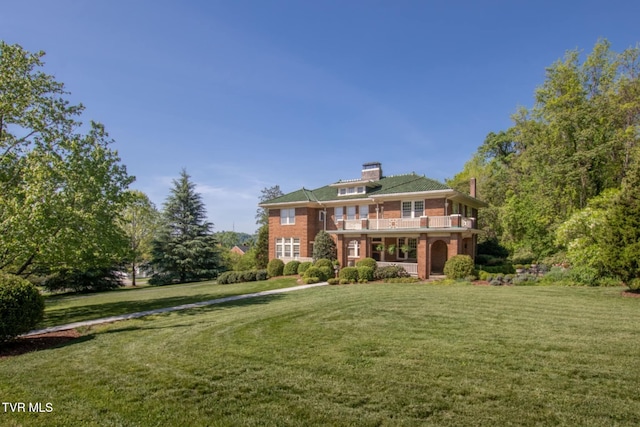 940 Park St, Bristol, VA 24201 - rear view of property featuring a balcony, a yard, brick siding, and a chimney