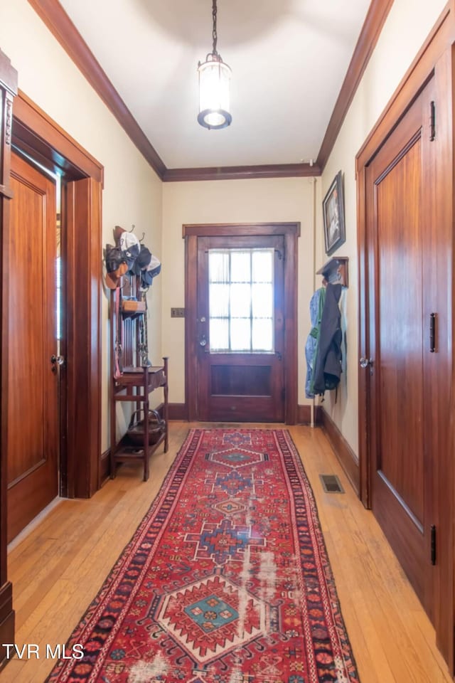 940 Park St, Bristol, VA 24201 - foyer with light wood-type flooring and crown molding