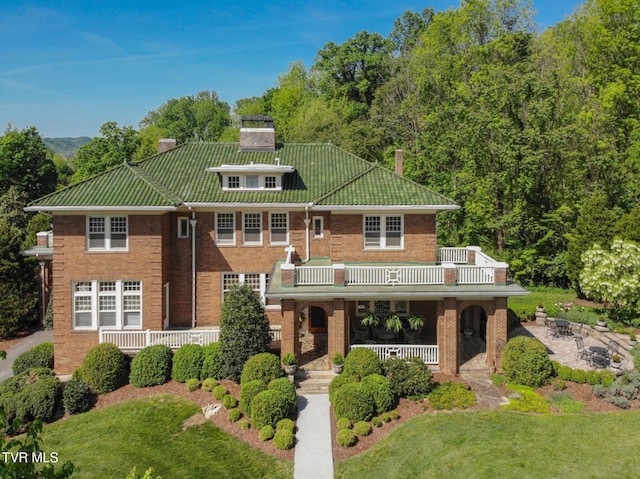 940 Park St, Bristol, VA 24201 - view of front of home featuring a porch, a chimney, a balcony, a front yard, and brick siding