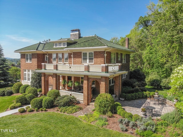 940 Park St, Bristol, VA 24201 - view of front of house featuring a chimney, a balcony, brick siding, covered porch, and a front yard