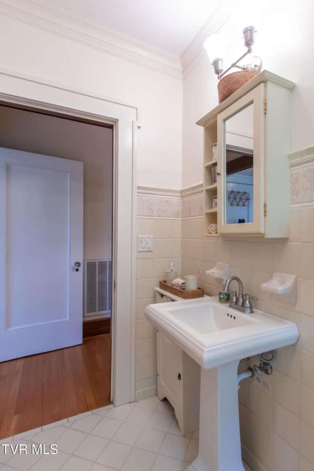 940 Park St, Bristol, VA 24201 - bathroom featuring ornamental molding, tile walls, wood finished floors, and a wainscoted wall