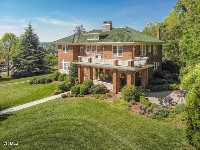 940 Park St, Bristol, VA 24201 - view of front of house with a balcony, brick siding, a front lawn, a chimney, and covered porch