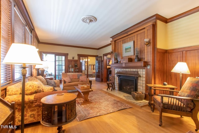 940 Park St, Bristol, VA 24201 - living area with ornamental molding, wood finished floors, a tile fireplace, a wainscoted wall, and wooden walls