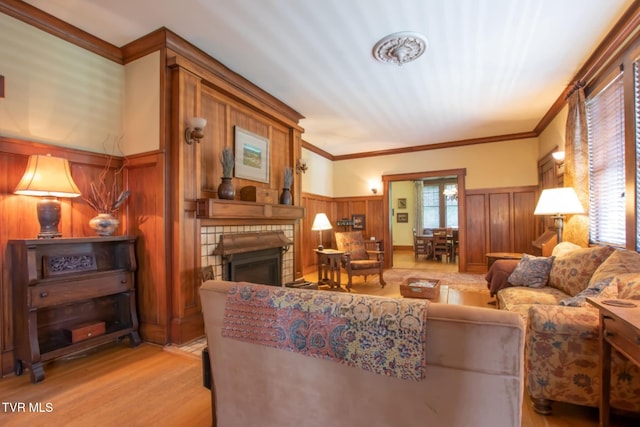 940 Park St, Bristol, VA 24201 - living room with a fireplace, light wood-type flooring, a wainscoted wall, crown molding, and wood walls