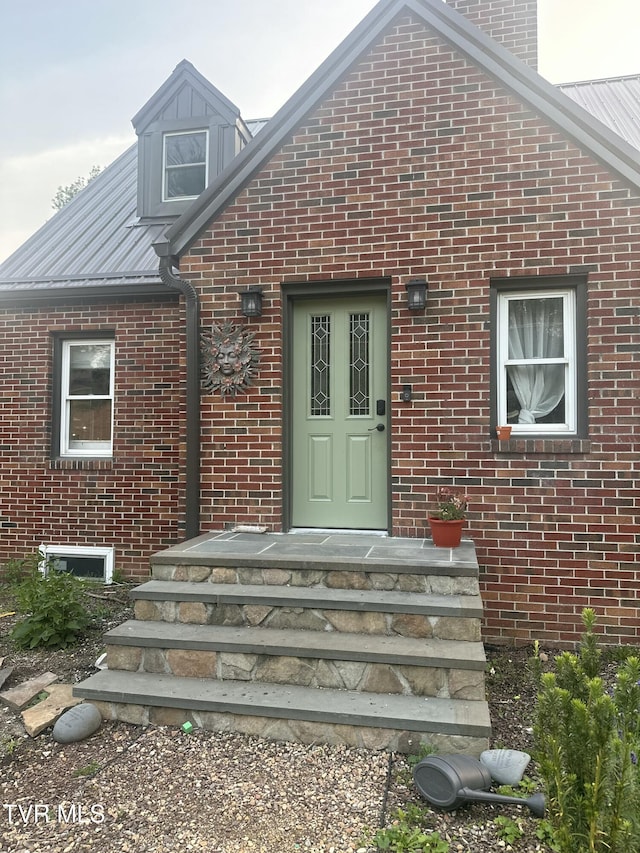 461 S Shady Ave, Damascus, VA 24236 - doorway to property with brick siding, a metal roof, and a chimney