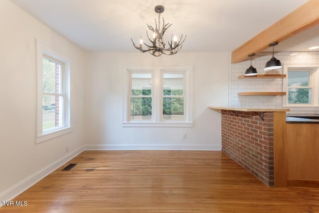 461 S Shady Ave, Damascus, VA 24236 - unfurnished dining area featuring a chandelier, light wood-style flooring, and beamed ceiling
