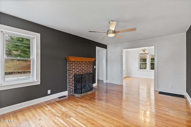 461 S Shady Ave, Damascus, VA 24236 - unfurnished living room with a fireplace, wood finished floors, ceiling fan, and a chandelier