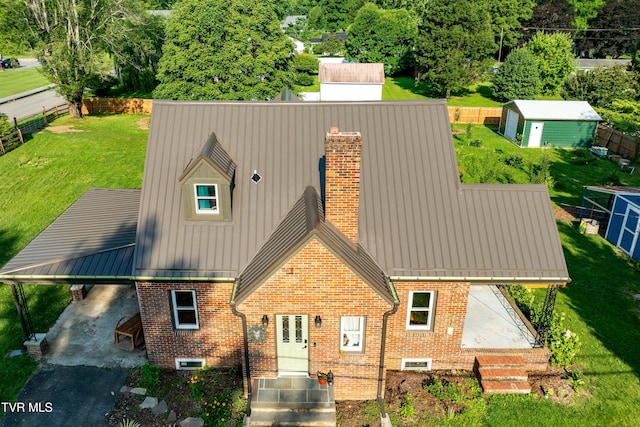 461 S Shady Ave, Damascus, VA 24236 - rear view of house featuring a chimney, brick siding, a standing seam roof, and a metal roof