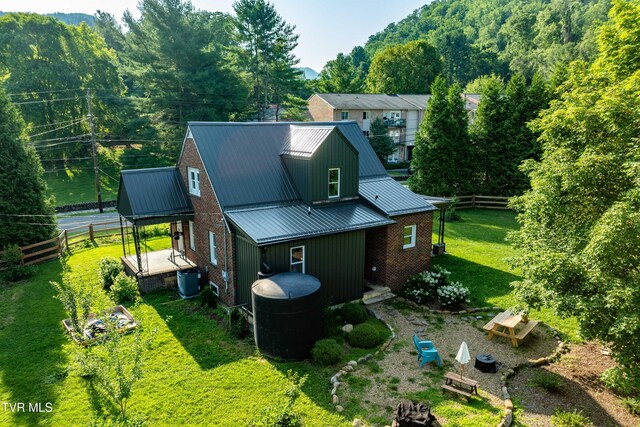 461 S Shady Ave, Damascus, VA 24236 - rear view of house with brick siding, a metal roof, and a deck