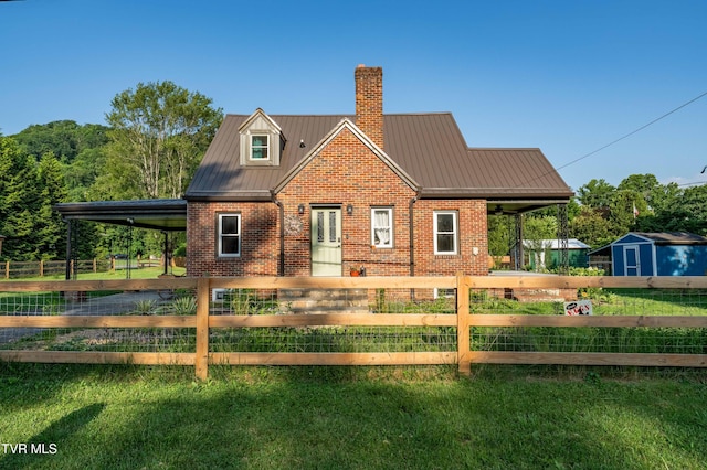 461 S Shady Ave, Damascus, VA 24236 - view of front facade featuring brick siding, a chimney, a metal roof, and a storage shed