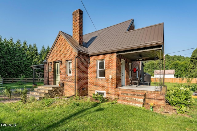 461 S Shady Ave, Damascus, VA 24236 - rear view of property featuring brick siding, ceiling fan, a chimney, a standing seam roof, and a metal roof