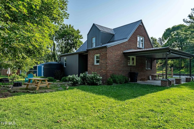 461 S Shady Ave, Damascus, VA 24236 - back of property featuring a patio area, brick siding, a lawn, and a metal roof