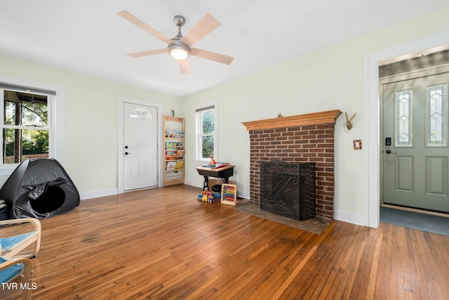 461 S Shady Ave, Damascus, VA 24236 - living area with hardwood / wood-style flooring, a brick fireplace, healthy amount of natural light, and a ceiling fan