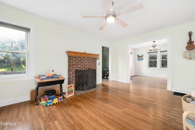 461 S Shady Ave, Damascus, VA 24236 - living room with healthy amount of natural light, a fireplace, hardwood / wood-style floors, and a chandelier