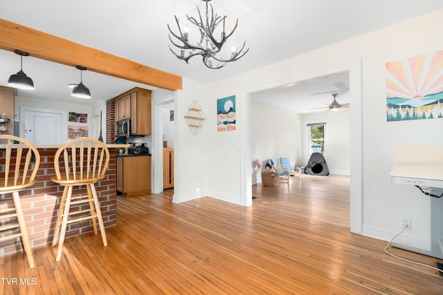 461 S Shady Ave, Damascus, VA 24236 - dining space featuring light wood-type flooring, a chandelier, a ceiling fan, and beamed ceiling