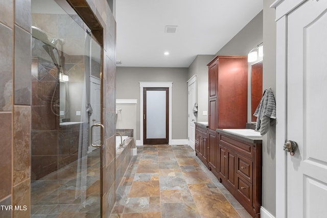 512 Shea Ct, Morristown, TN 37814 - bathroom with stone finish floors, a shower stall, a garden tub, vanity, and recessed lighting