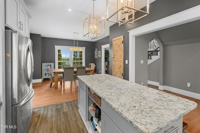 512 Shea Ct, Morristown, TN 37814 - kitchen featuring freestanding refrigerator, a chandelier, dark wood-style flooring, a center island, and recessed lighting