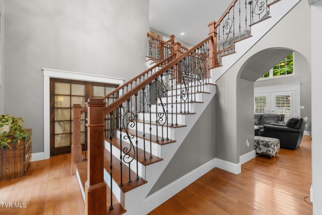 512 Shea Ct, Morristown, TN 37814 - staircase with arched walkways, a towering ceiling, and wood-type flooring