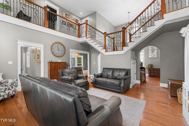 512 Shea Ct, Morristown, TN 37814 - living room with a high ceiling, arched walkways, wood finished floors, stairs, and recessed lighting
