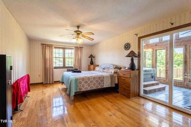 274 Hickam Orchard Rd, Kingsport, TN 37660 - bedroom with wallpapered walls, a textured ceiling, access to outside, light wood-style floors, and ceiling fan