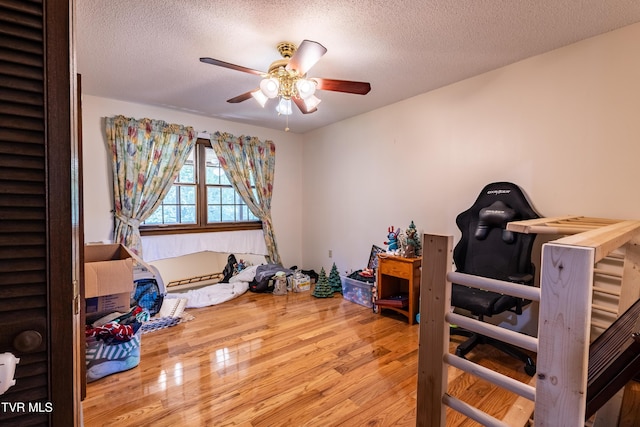 274 Hickam Orchard Rd, Kingsport, TN 37660 - bedroom featuring wood finished floors, a textured ceiling, and a ceiling fan