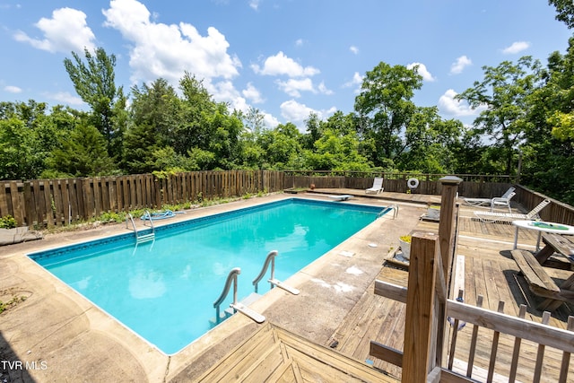 274 Hickam Orchard Rd, Kingsport, TN 37660 - view of swimming pool with a fenced backyard, a deck, and view of wooded area