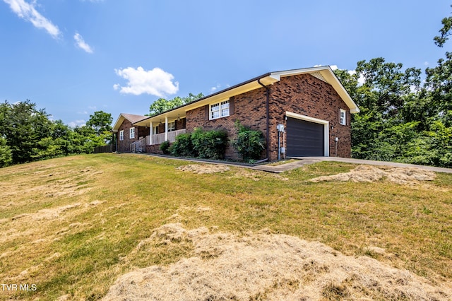 274 Hickam Orchard Rd, Kingsport, TN 37660 - view of home's exterior with brick siding, a garage, and a lawn