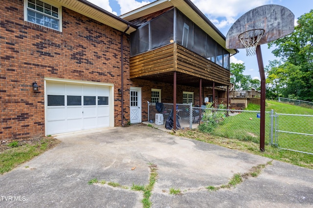 274 Hickam Orchard Rd, Kingsport, TN 37660 - exterior space featuring brick siding, asphalt driveway, an attached garage, a sunroom, and a gate