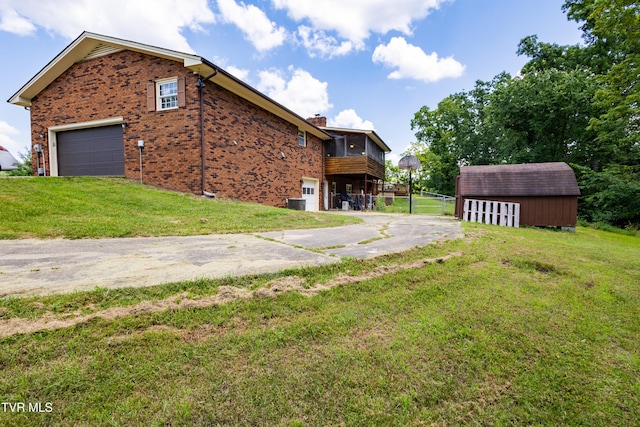 274 Hickam Orchard Rd, Kingsport, TN 37660 - rear view of property with brick siding, a storage unit, a chimney, driveway, and an attached garage