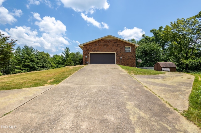 274 Hickam Orchard Rd, Kingsport, TN 37660 - view of front of home with brick siding, concrete driveway, a front yard, and an outbuilding