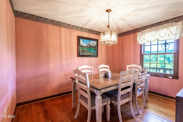 274 Hickam Orchard Rd, Kingsport, TN 37660 - dining room with a chandelier, wood finished floors, and a textured ceiling