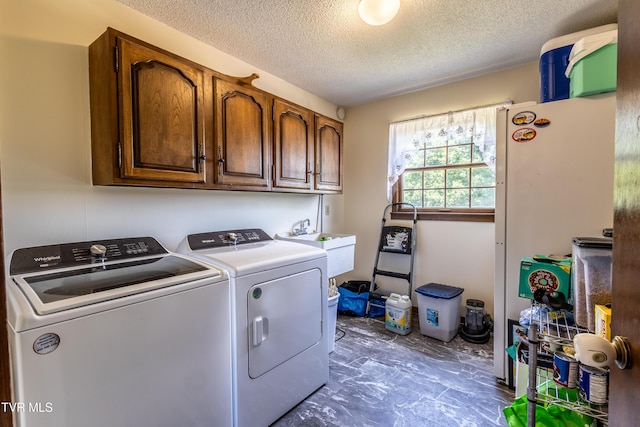 274 Hickam Orchard Rd, Kingsport, TN 37660 - laundry room with washing machine and clothes dryer, cabinet space, a textured ceiling, and marble finish floors
