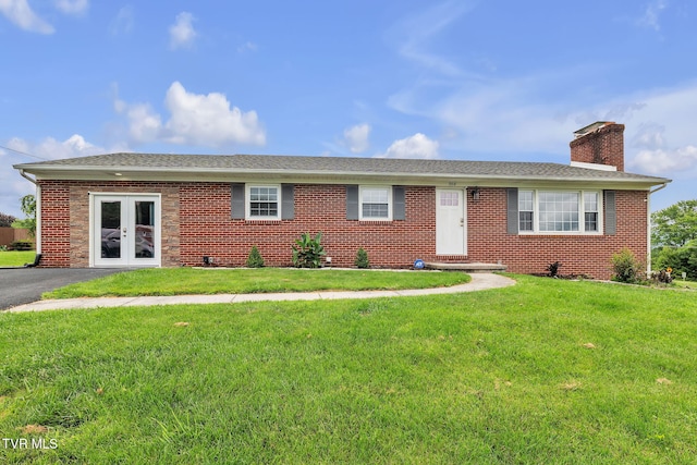 908 Middle Ave, Marion, VA 24354 - ranch-style home featuring a front yard, a chimney, brick siding, french doors, and a shingled roof