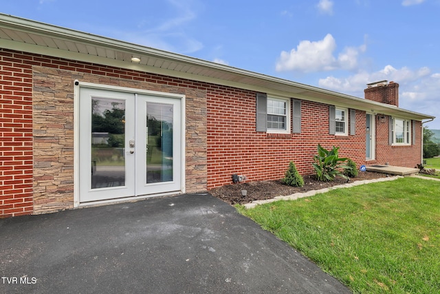 908 Middle Ave, Marion, VA 24354 - view of front of home featuring french doors, a chimney, stone siding, and brick siding