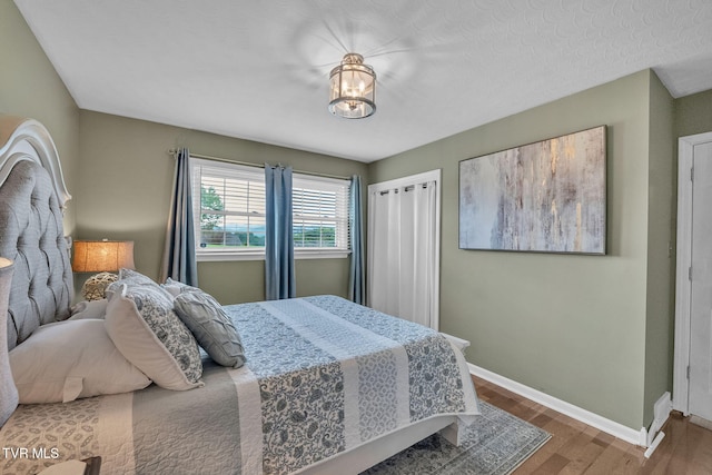 908 Middle Ave, Marion, VA 24354 - bedroom with wood finished floors and a chandelier
