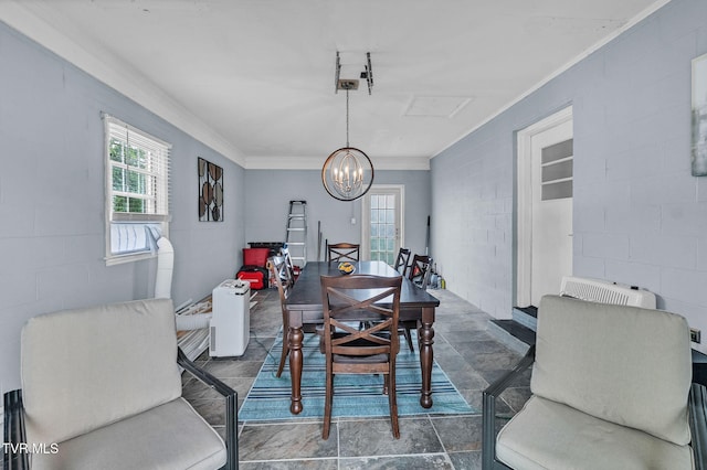 908 Middle Ave, Marion, VA 24354 - dining room with ornamental molding, a chandelier, concrete block wall, and dark stone finish flooring
