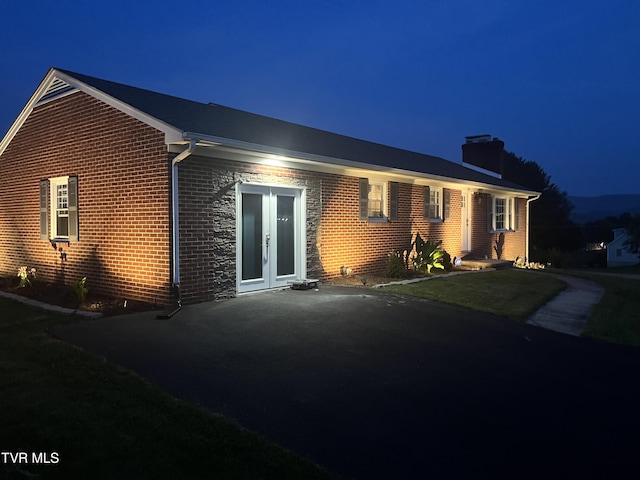 908 Middle Ave, Marion, VA 24354 - view of front of house featuring a chimney, brick siding, and french doors