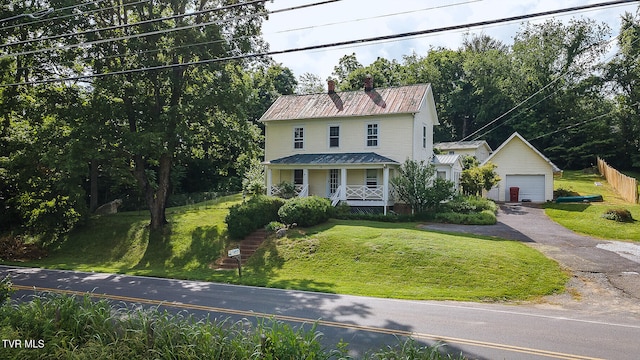 1330 Carroll Creek Rd, Gray, TN 37615 - view of front of house featuring covered porch, a chimney, a front yard, a detached garage, and a metal roof