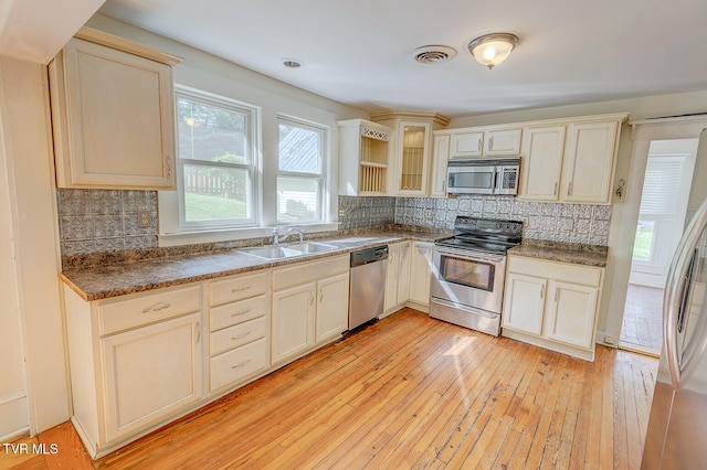 1330 Carroll Creek Rd, Gray, TN 37615 - kitchen featuring stainless steel appliances, tasteful backsplash, light wood-style floors, and glass insert cabinets