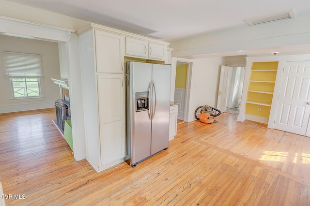 1330 Carroll Creek Rd, Gray, TN 37615 - kitchen with stainless steel fridge with ice dispenser, light wood-type flooring, white cabinetry, and a fireplace